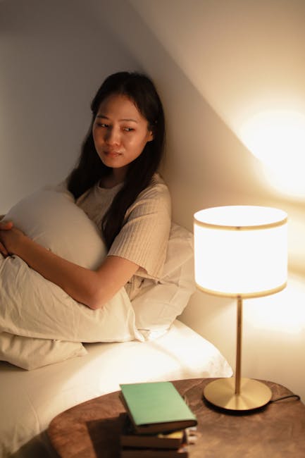 A person sitting comfortably with a laptop, looking thoughtful and at peace